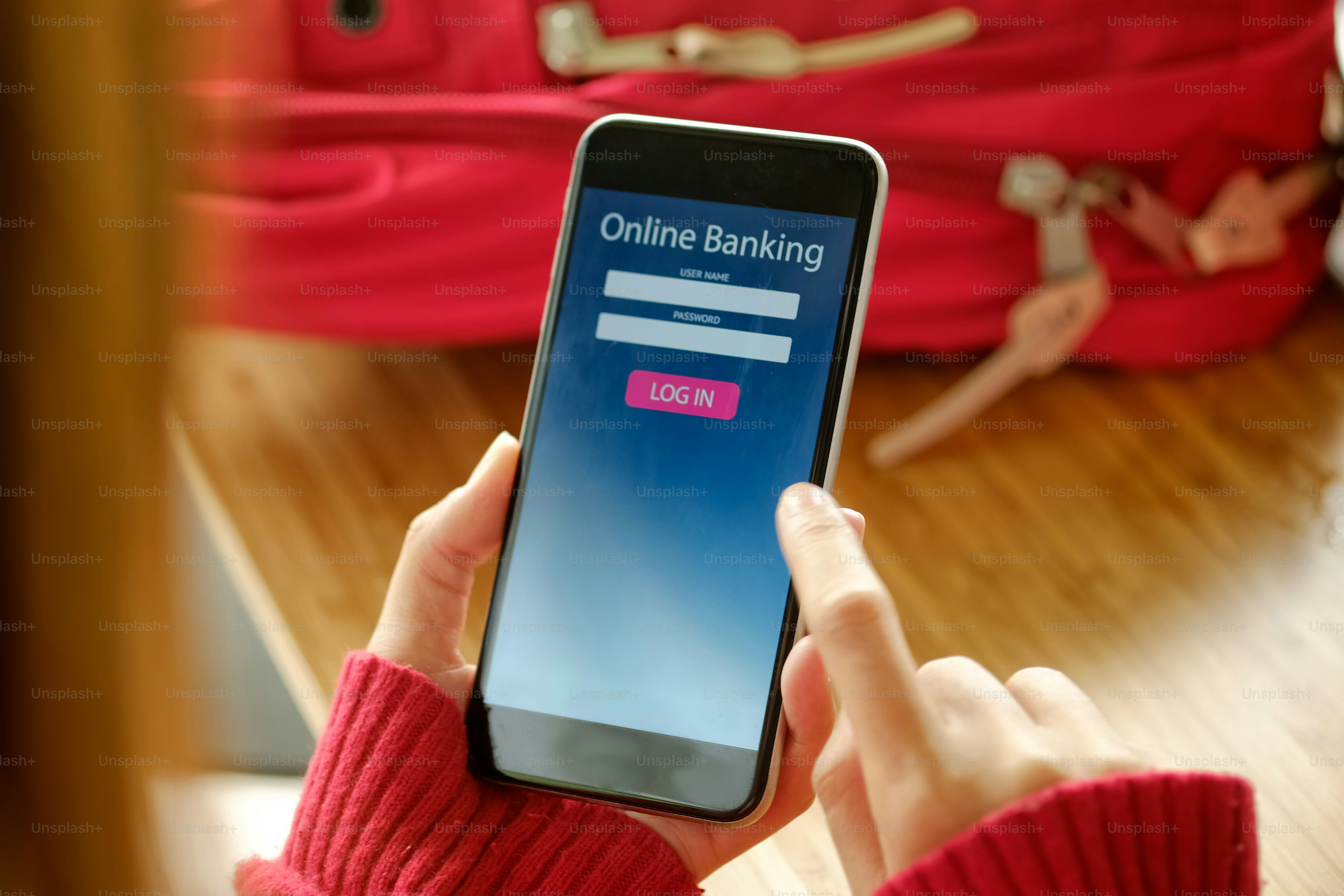 e-banking concept: Young woman with online banking application phone at the desk work.