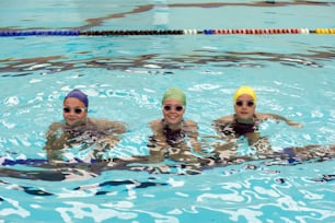 a group of people swimming in a pool