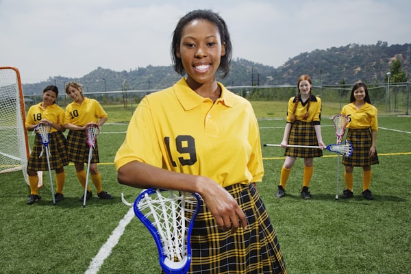 Junior tennis player meeting the camera gaze while gripping a racket