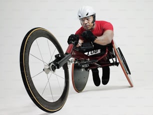 a man in a wheel chair with a helmet on