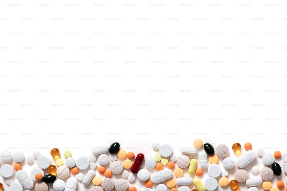 different colorful pills on the white background. copy space