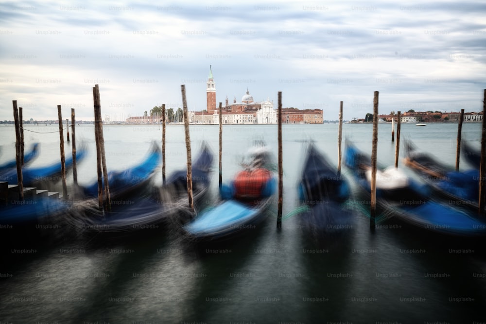 Gondolas in Venice, Italy from St Mark's Square (Piazza san Marco) with gorgeous view of San Giorgio Maggiore Church. Venice is famous travel destination of Italy for its unique cityscape and culture.