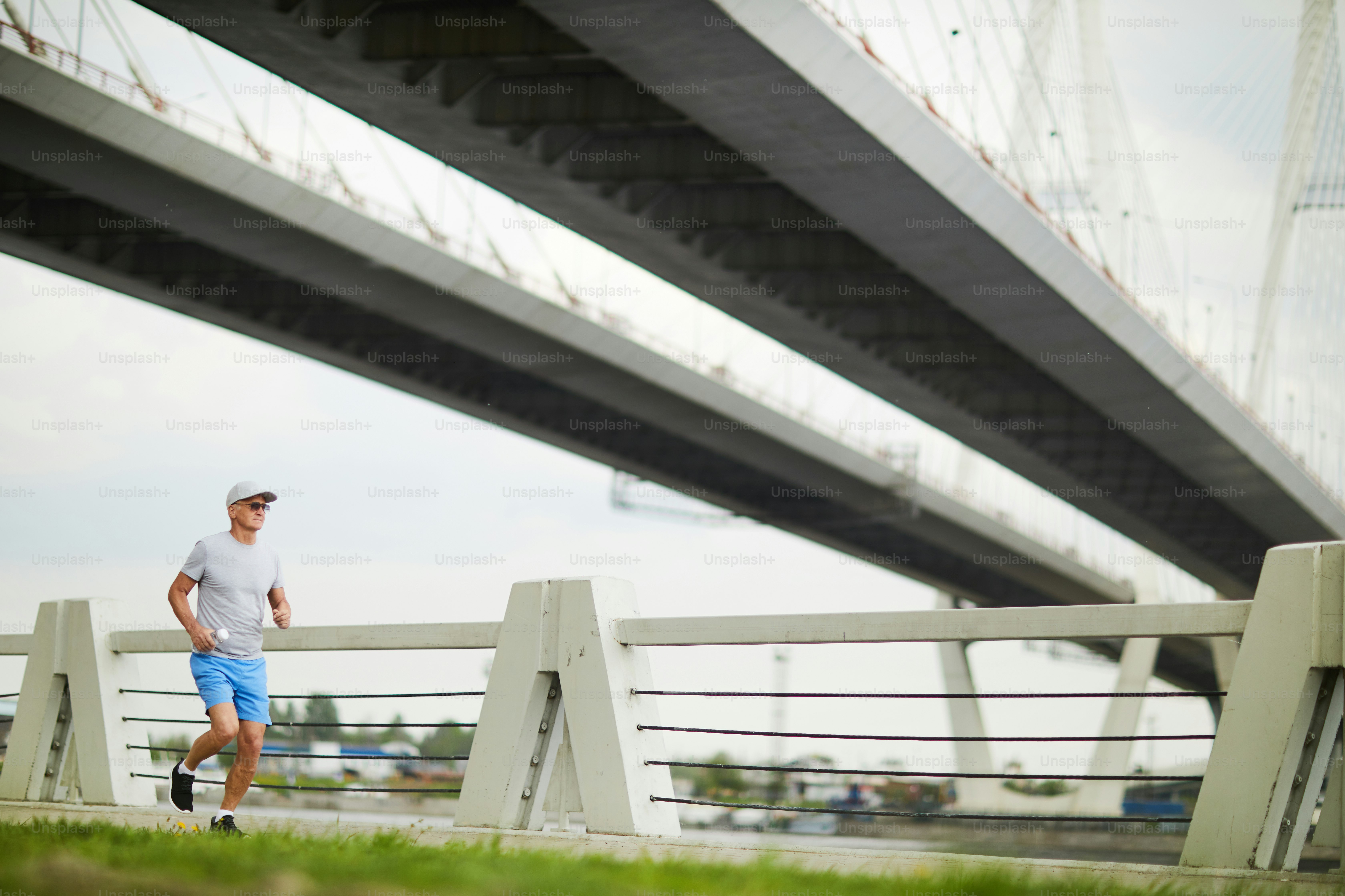 Mature sportsman in activewear having workout in the morning in urban environment