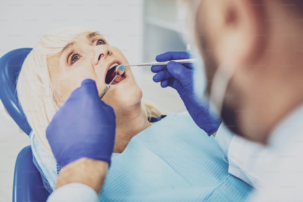 It is ok. Mature female person keeping mouth opened while visiting doctor