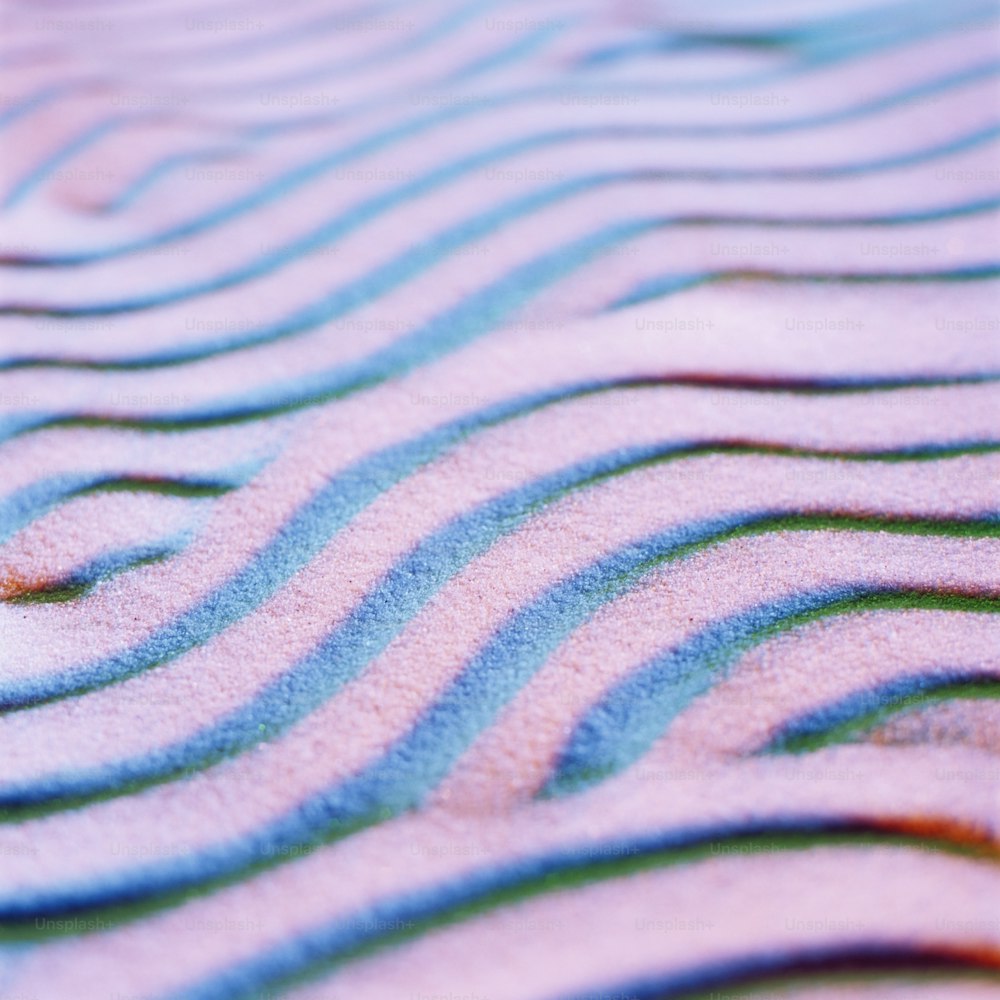 a close up of a wave pattern on sand