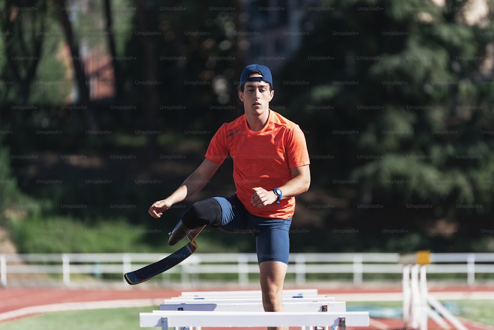 Disabled man athlete training with leg prosthesis. Paralympic Sport Concept.