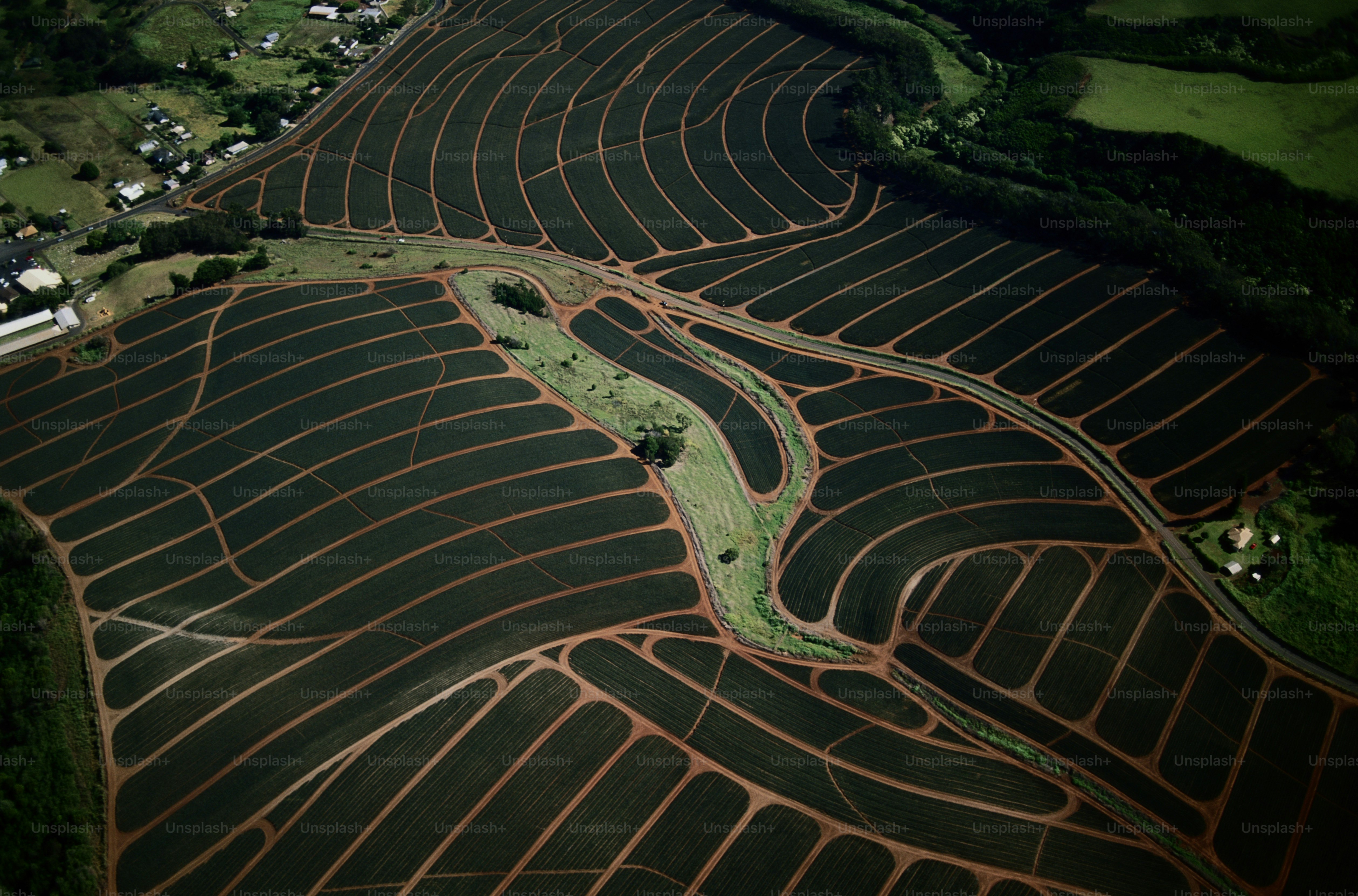 an aerial view of a field with a river running through it