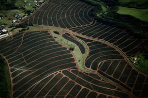 an aerial view of a field with a river running through it