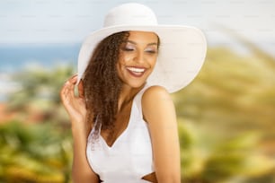 Beauty portrait of young african american girl with afro hairstyle in summer hat. Smiling beautiful woman. Vacation concept