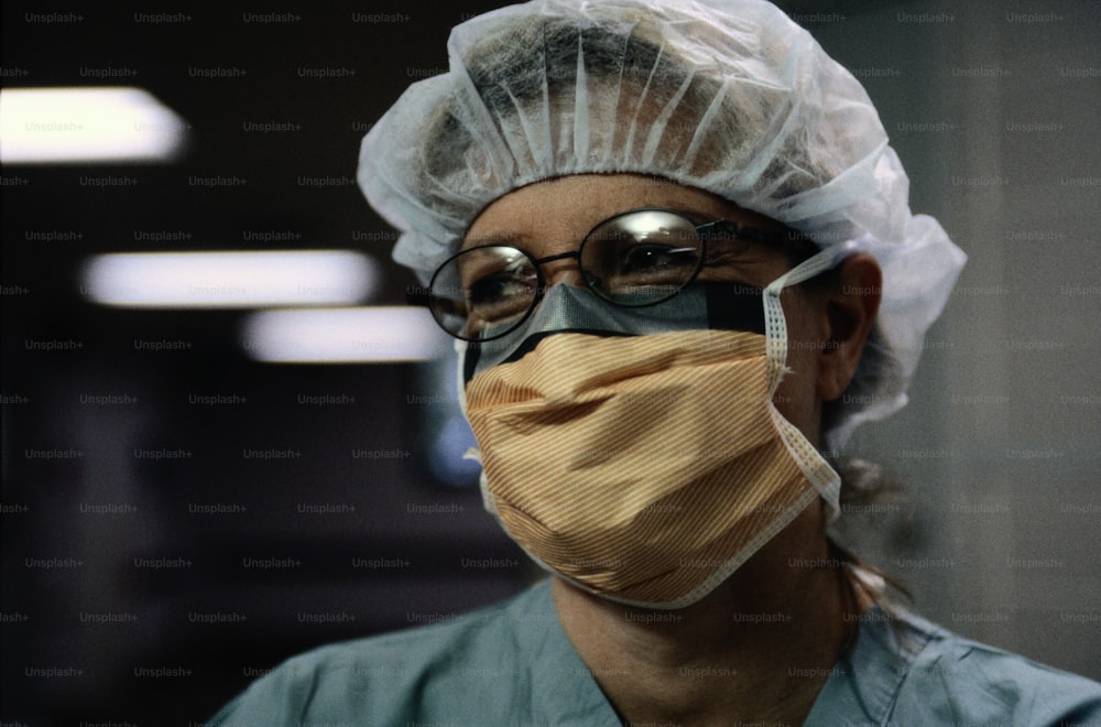 a man wearing a surgical mask and protective glasses