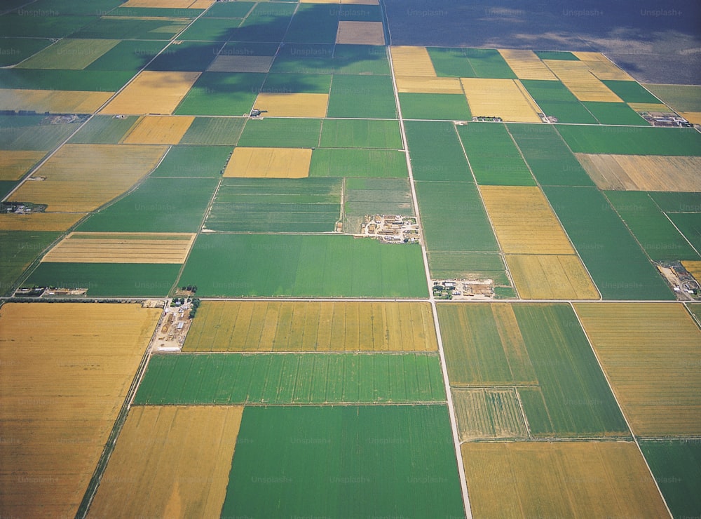 an aerial view of a green and yellow field
