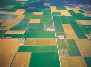 an aerial view of a green and yellow field