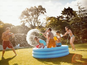 a group of people playing in an inflatable pool