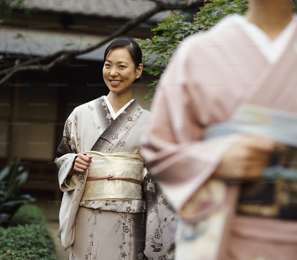a woman in a kimono smiles at the camera