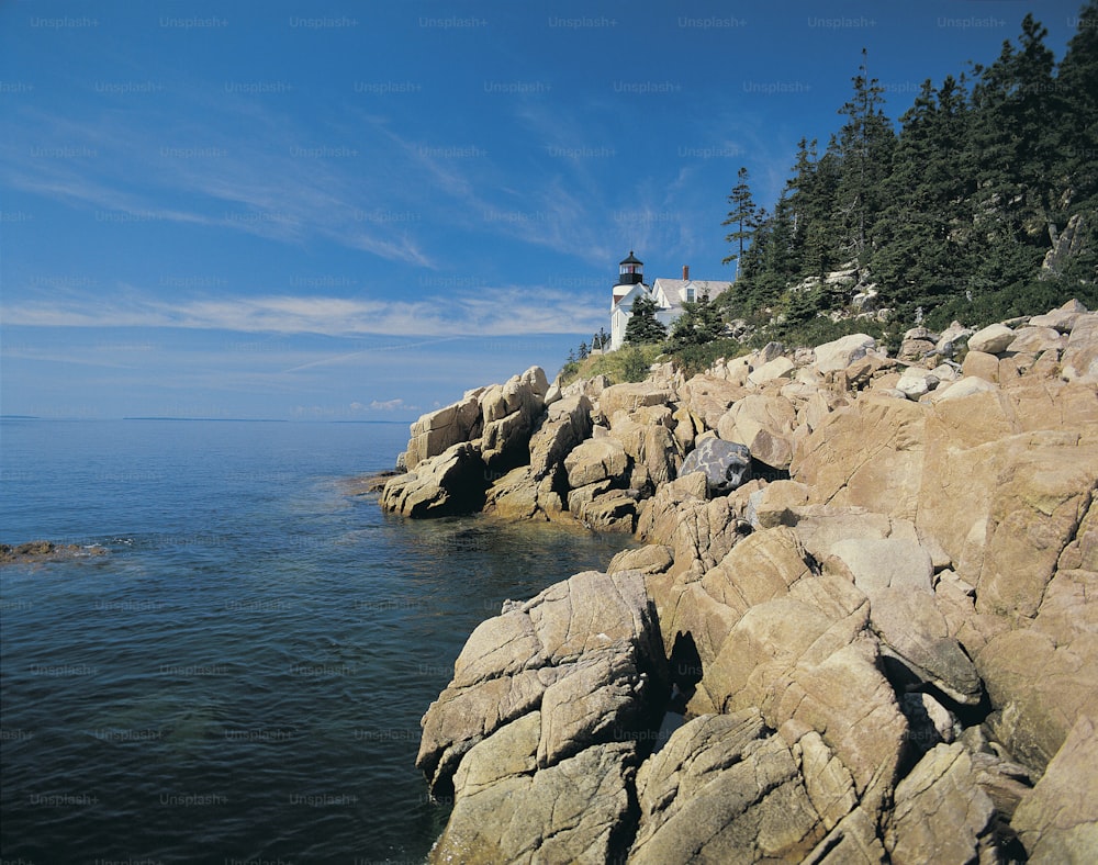 a light house on a rocky cliff overlooking the ocean