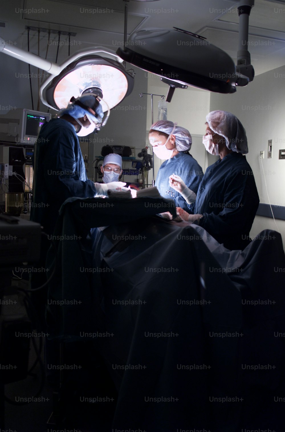 a group of doctors standing around a patient