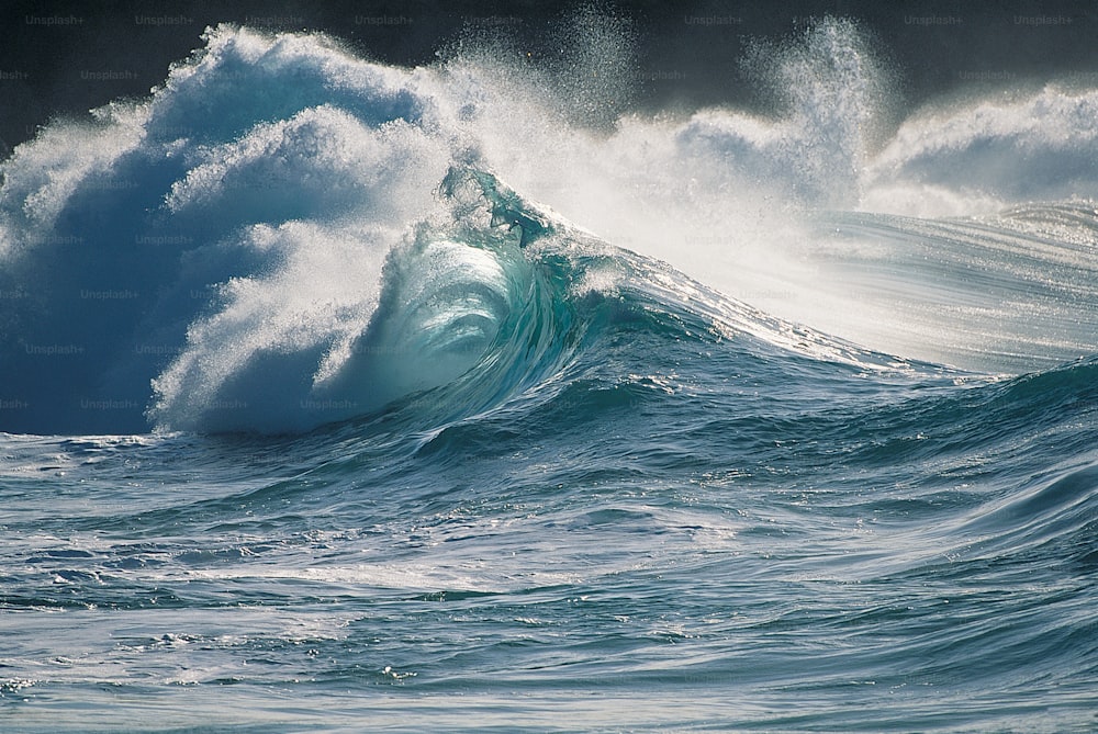 a large wave in the middle of the ocean