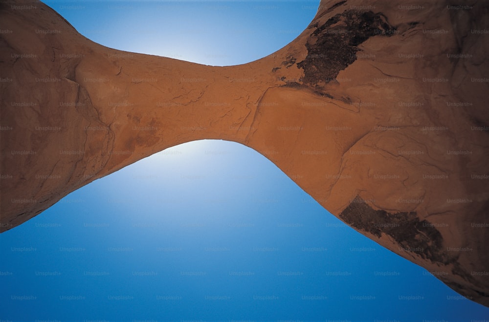 a large rock formation with a blue sky in the background