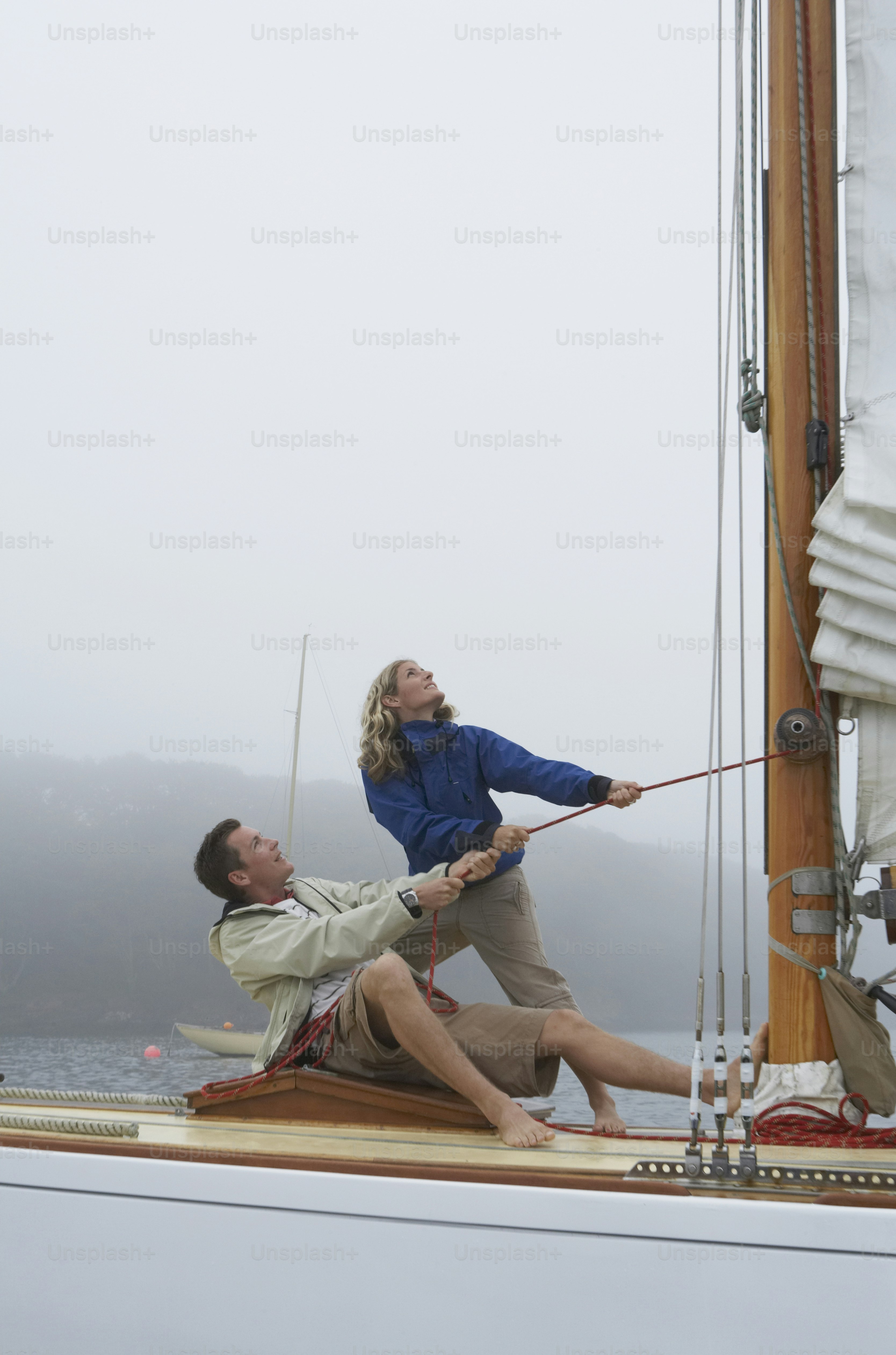 a man and a woman on a sail boat