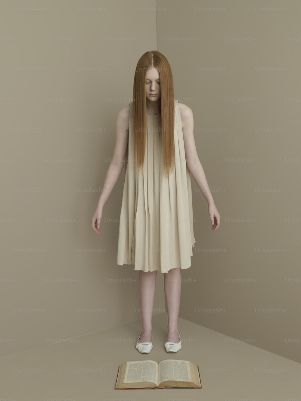 a woman with long hair standing on a book