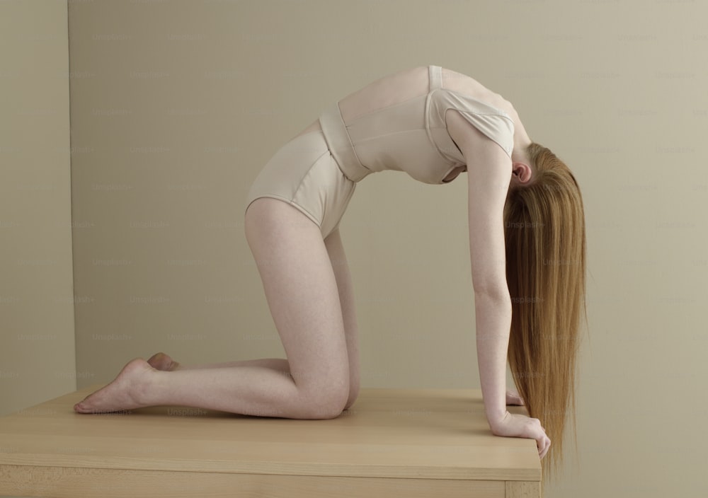 a woman with long hair is doing a yoga pose