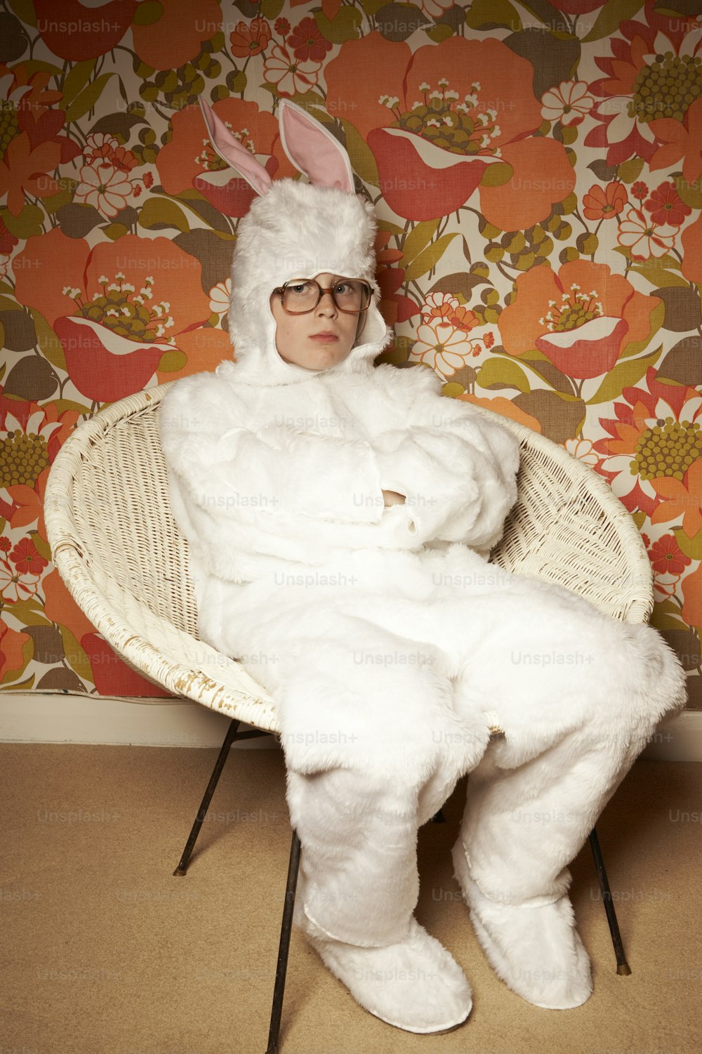 a man in a bunny suit sitting in a chair