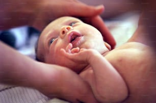 a close up of a person holding a baby