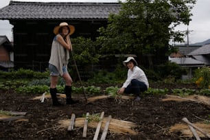 a couple of women standing next to each other in a field