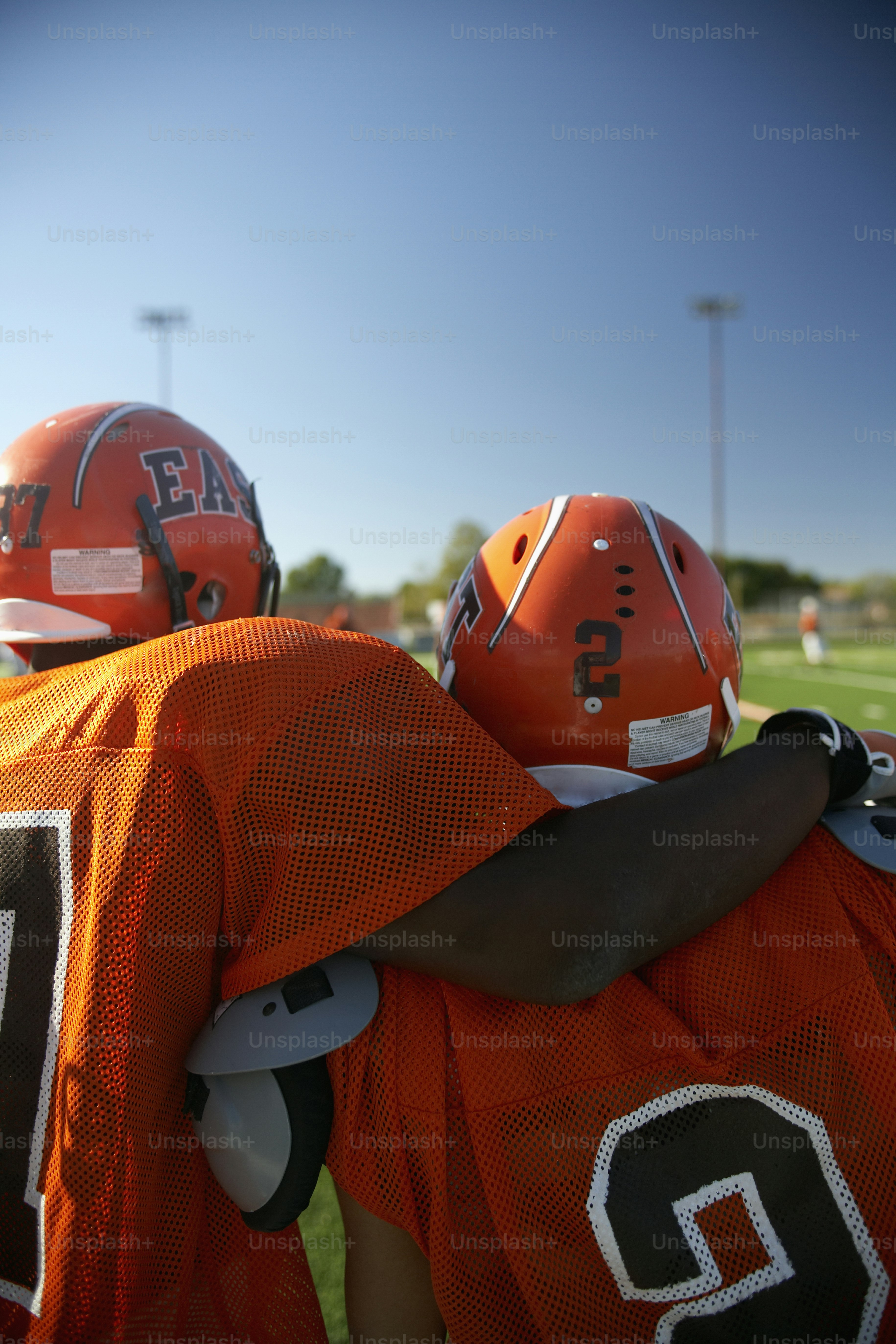 a group of football players standing on top of a field