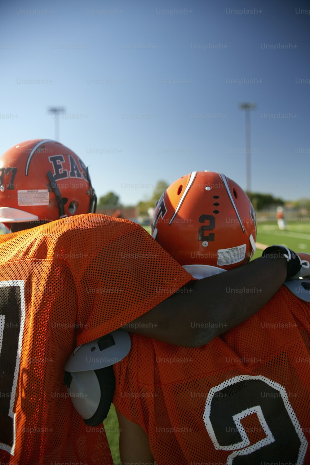 a group of football players standing on top of a field