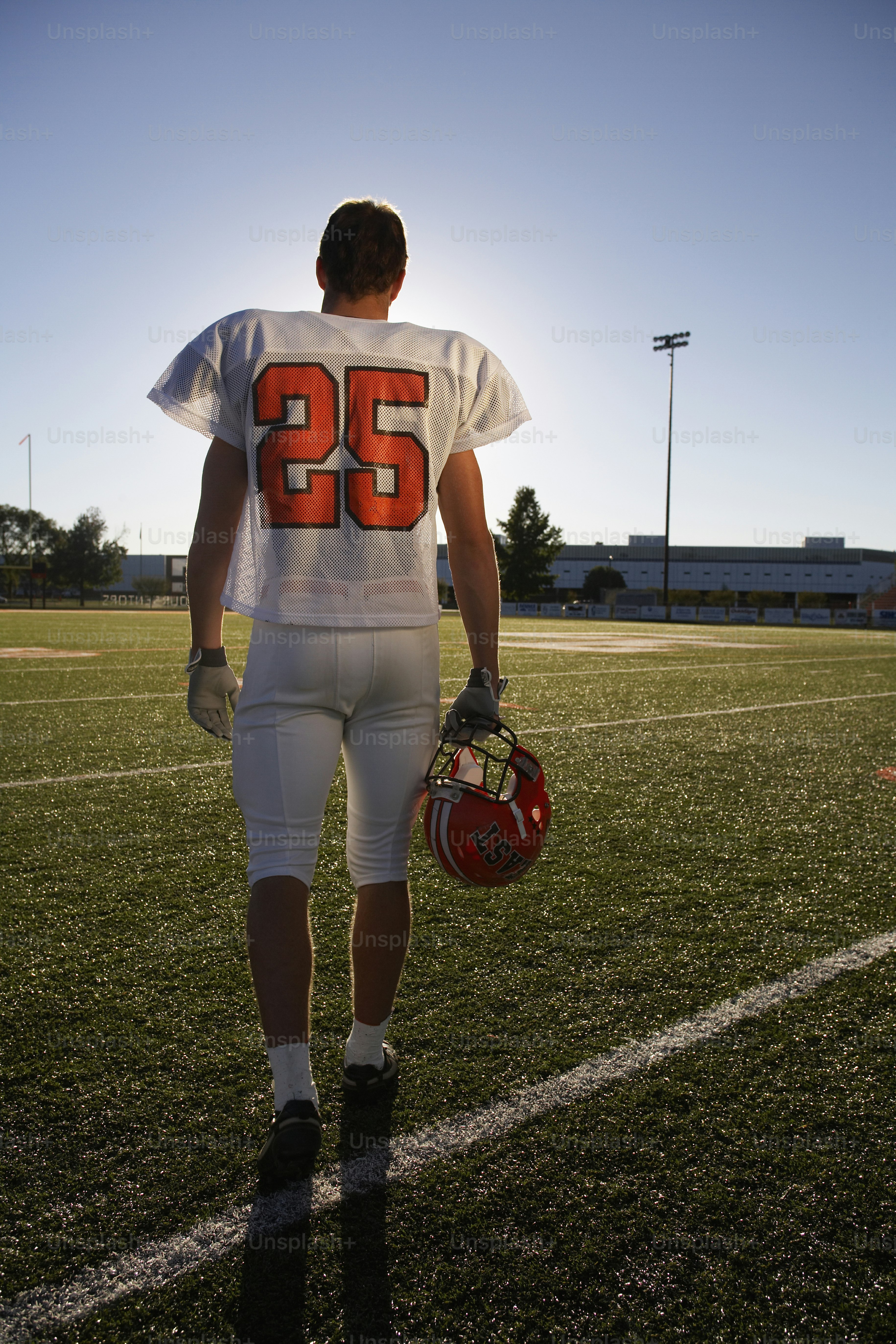 a football player is walking on the field