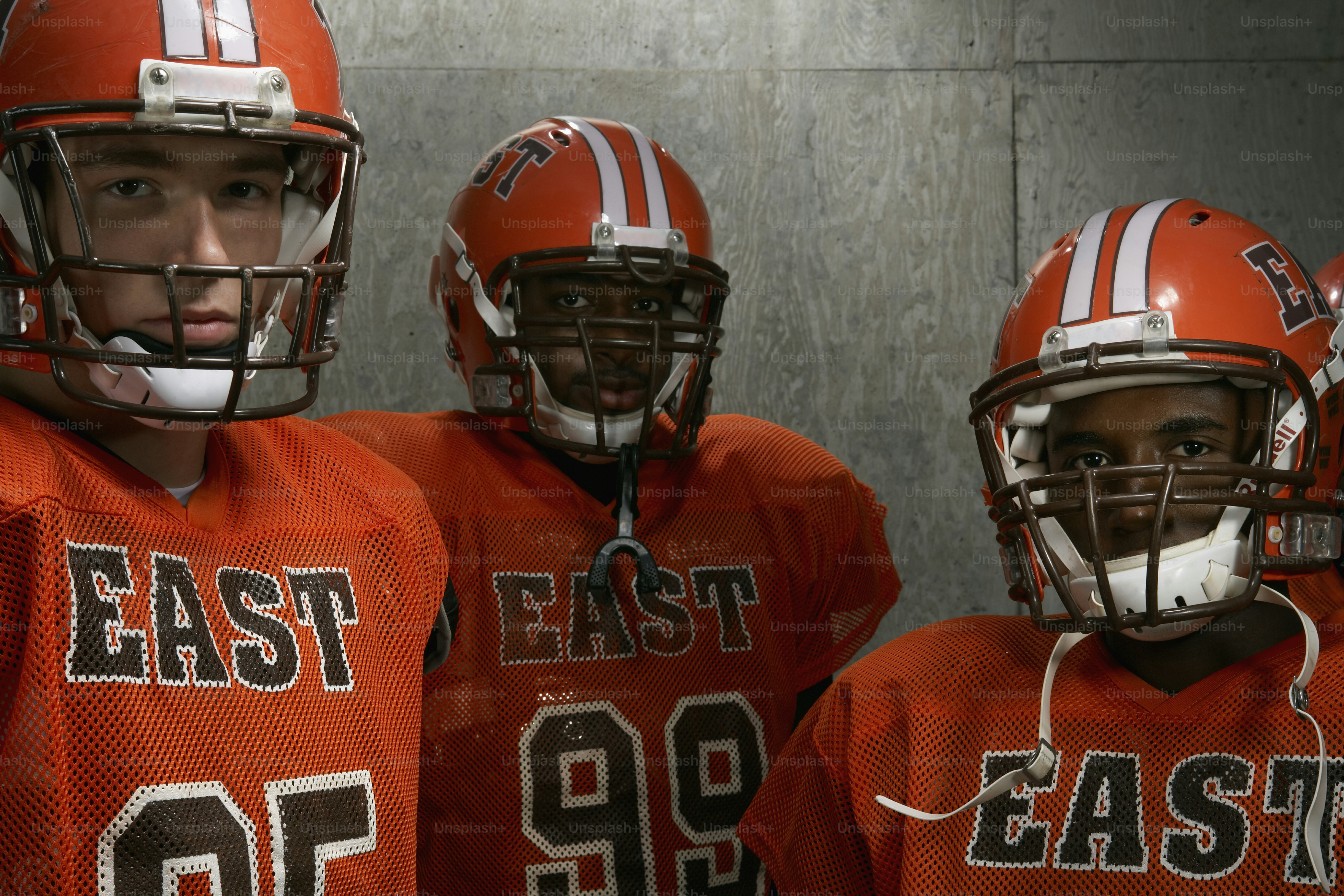 a group of young football players standing next to each other