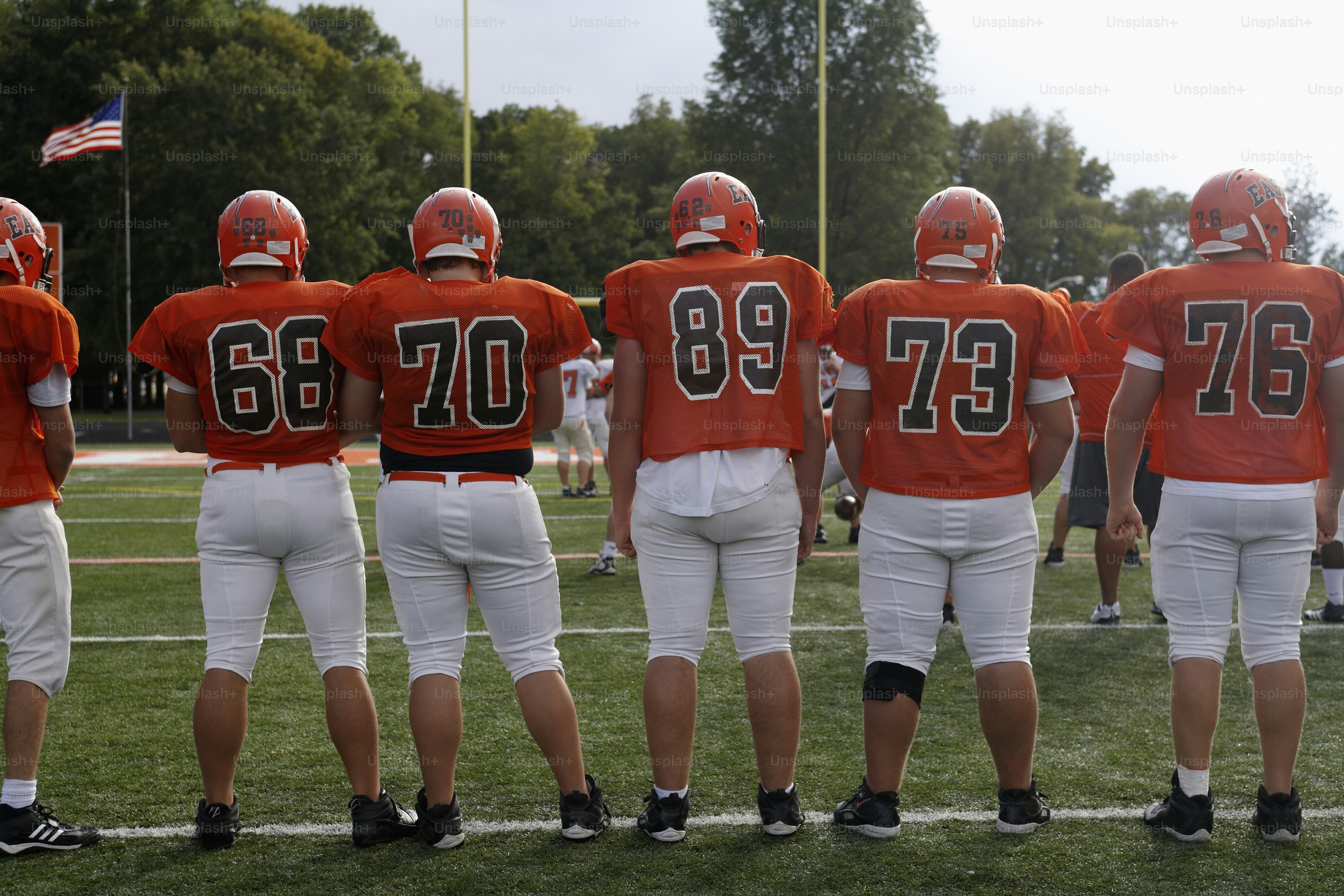 a group of football players standing on top of a field