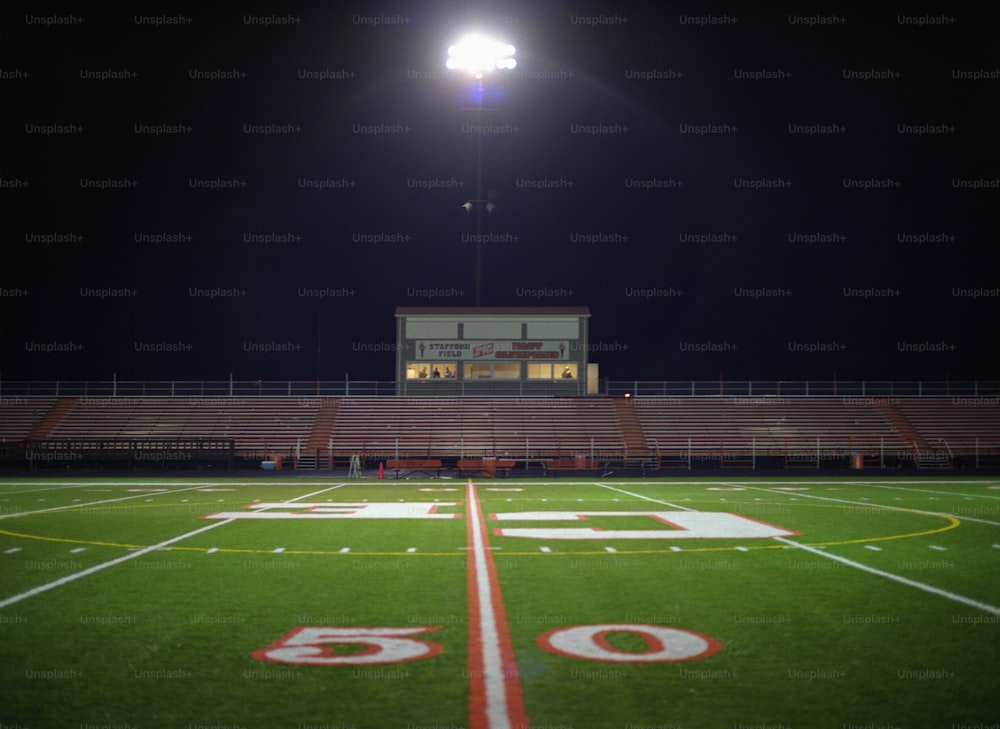 Illuminated American football field at night