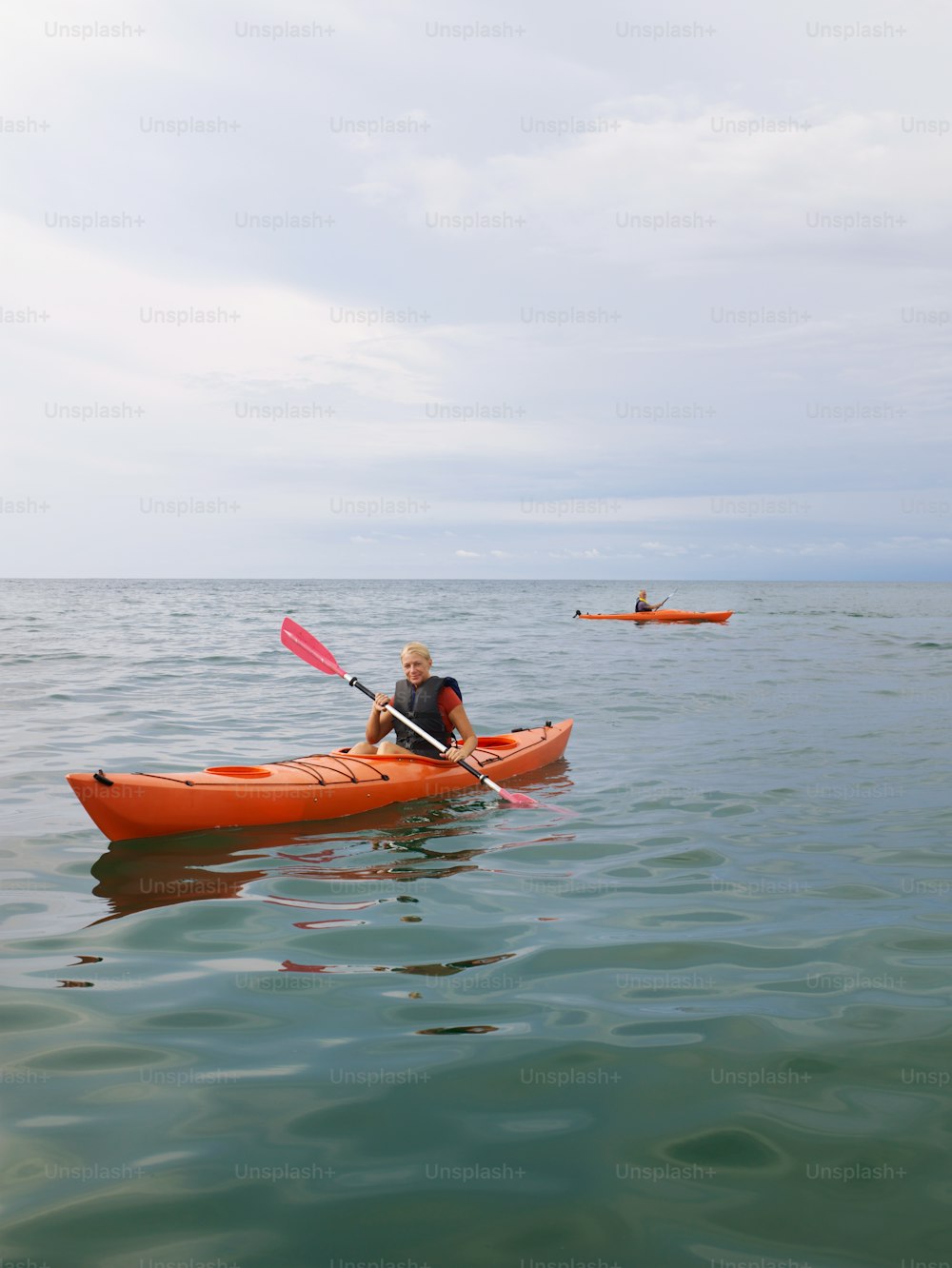 a man is paddling a kayak in the water