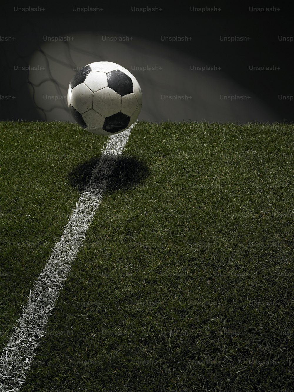 a soccer ball sitting on top of a lush green field