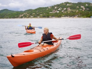 two people in kayaks paddling on the water