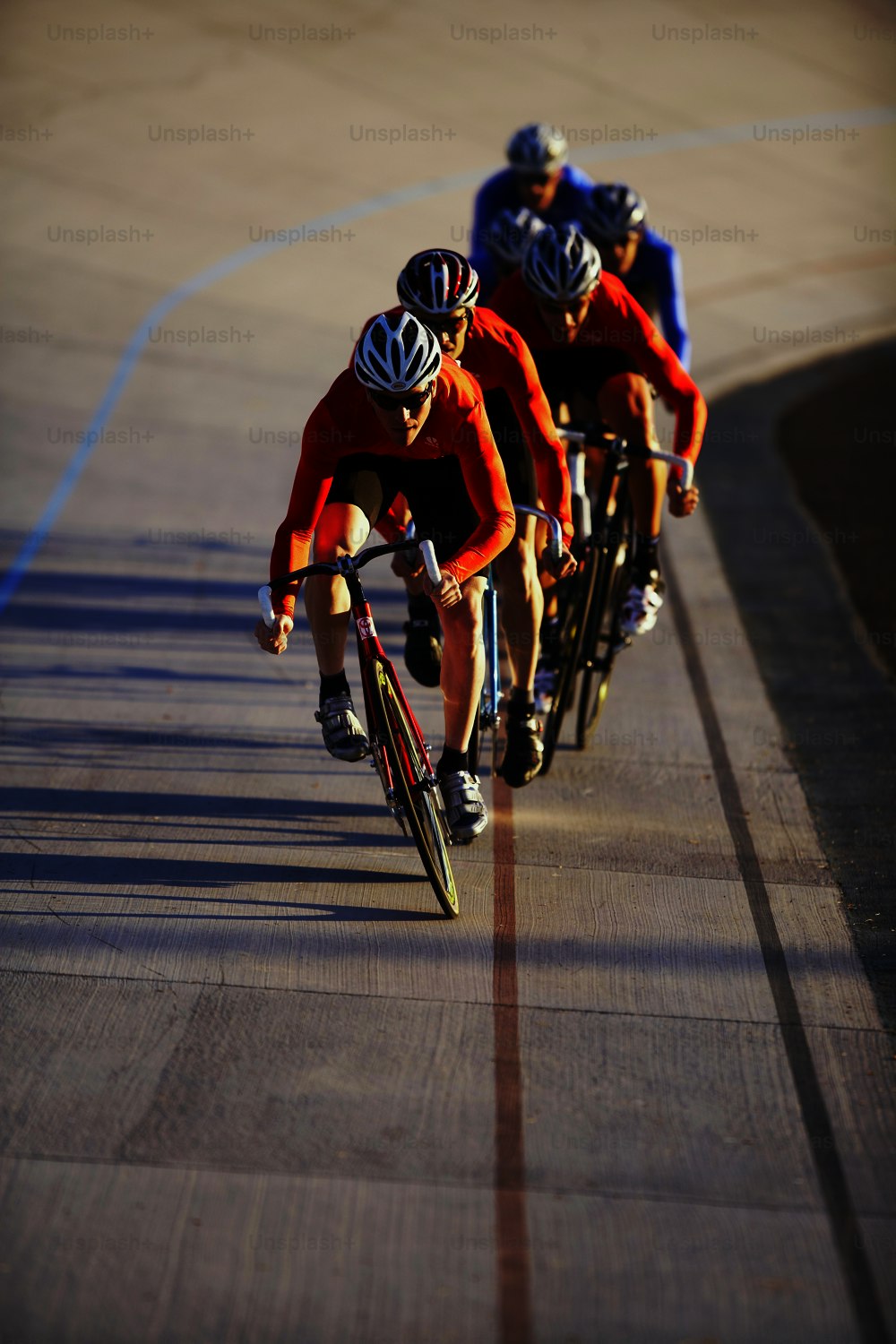 a group of people riding bikes down a road