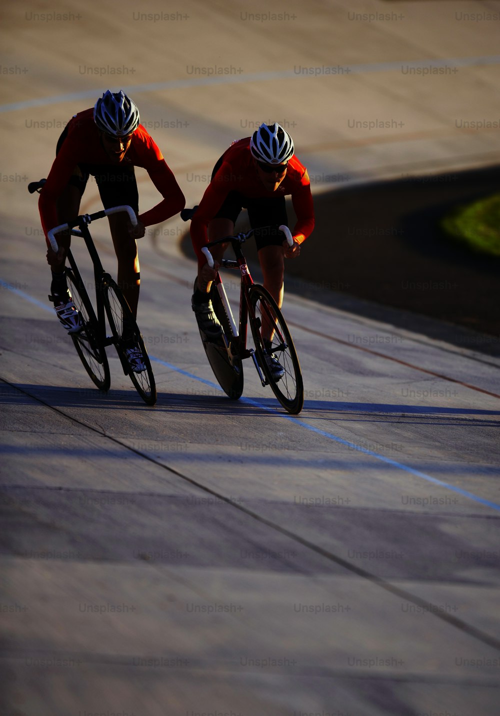 two bicyclists racing down a paved road