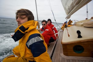 a group of men riding on the back of a boat