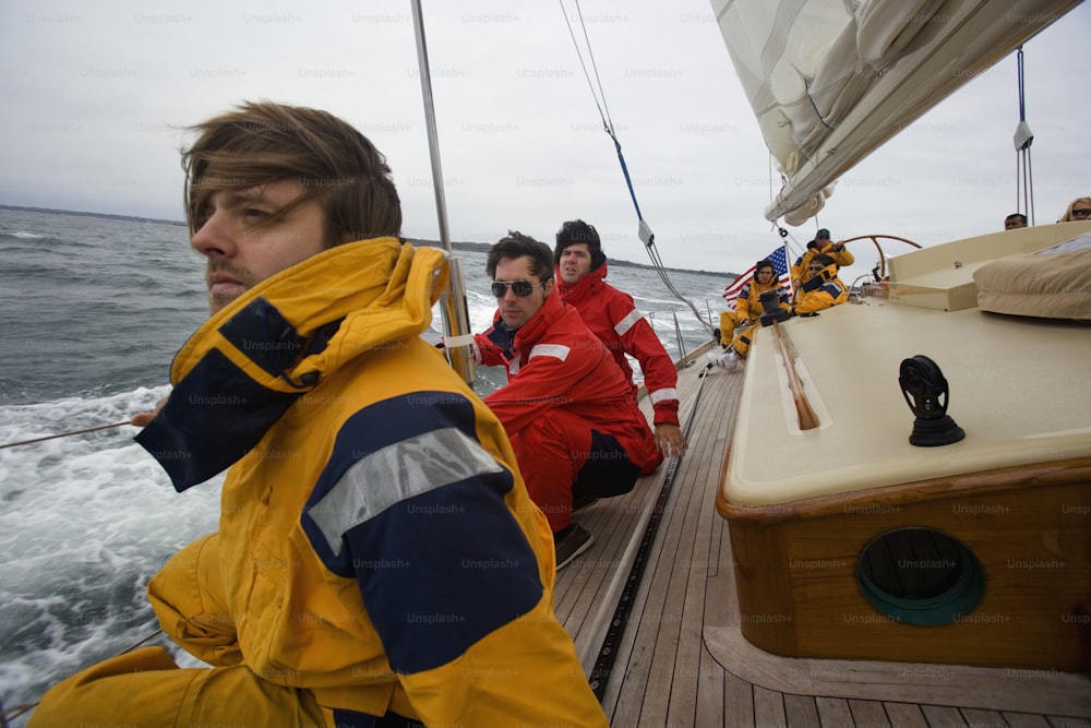 a group of men riding on the back of a boat