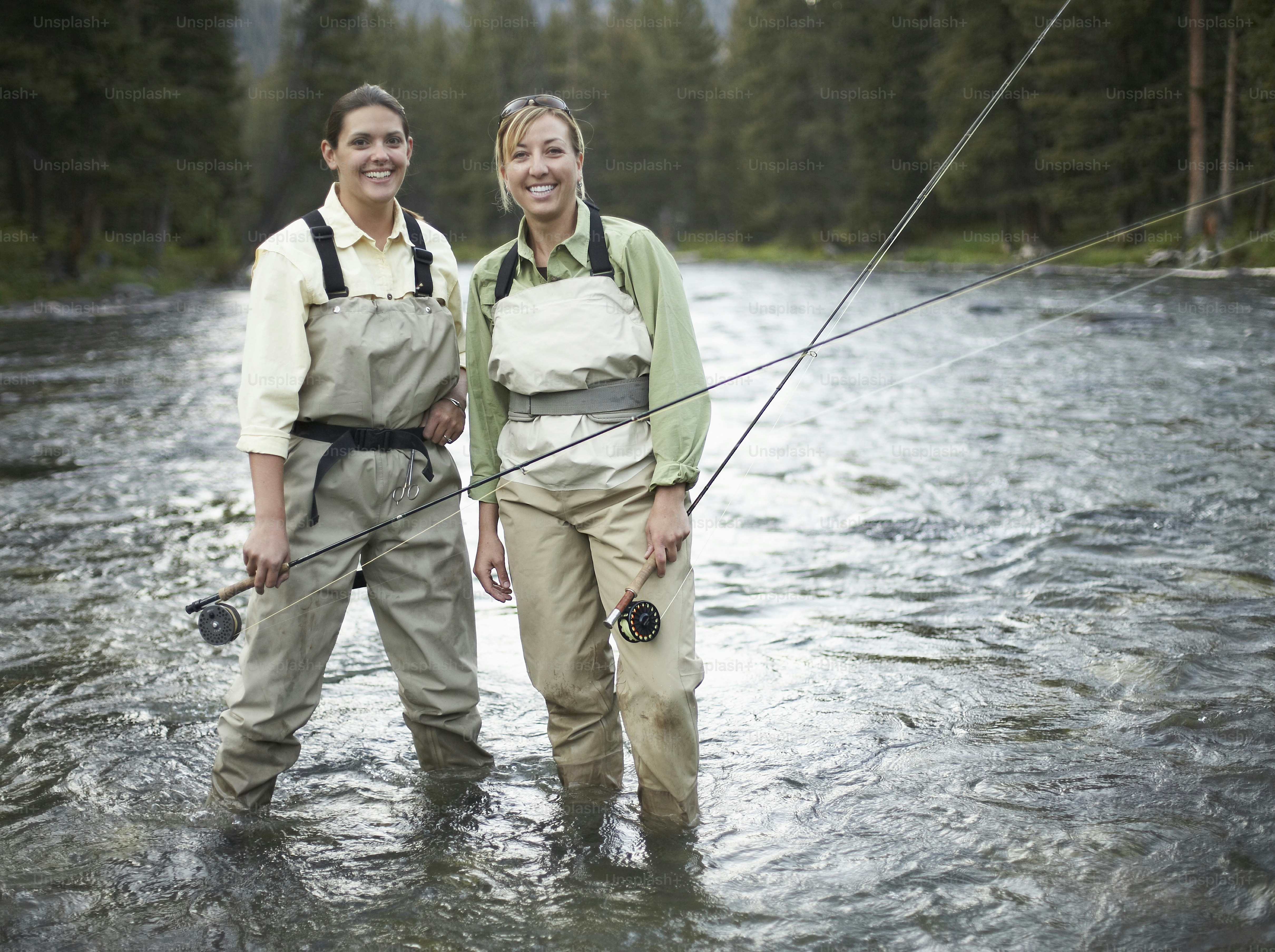 Two people fly fishing in a river