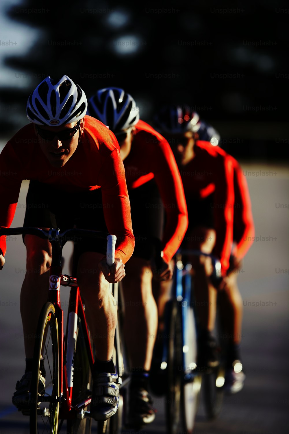 a group of people riding bikes down a street