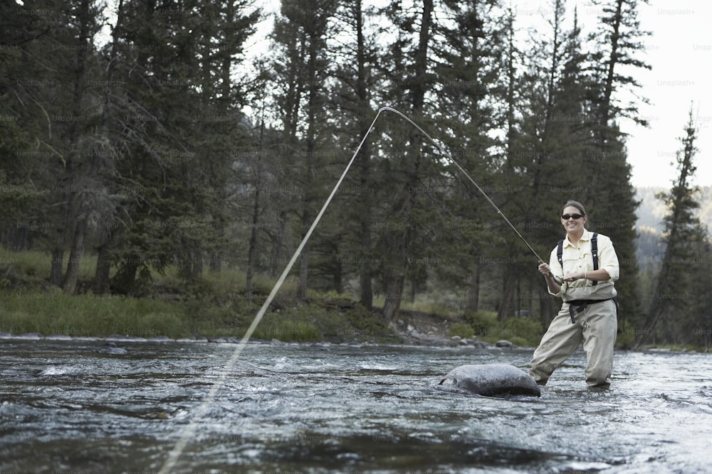 Woman fishing in river — Stock Photo © phb.cz #25051789