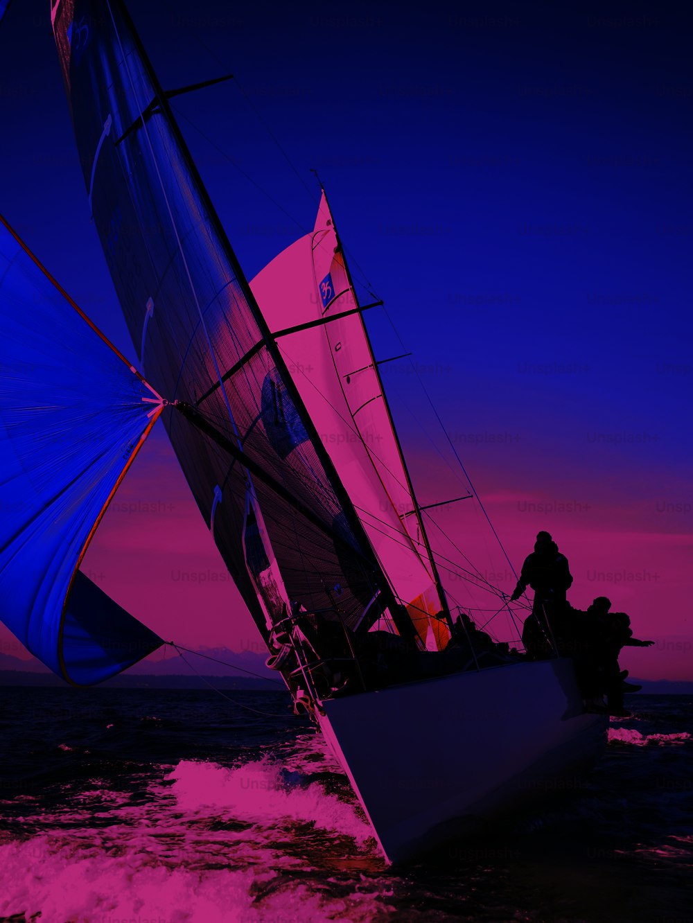 two people on a sailboat in the ocean