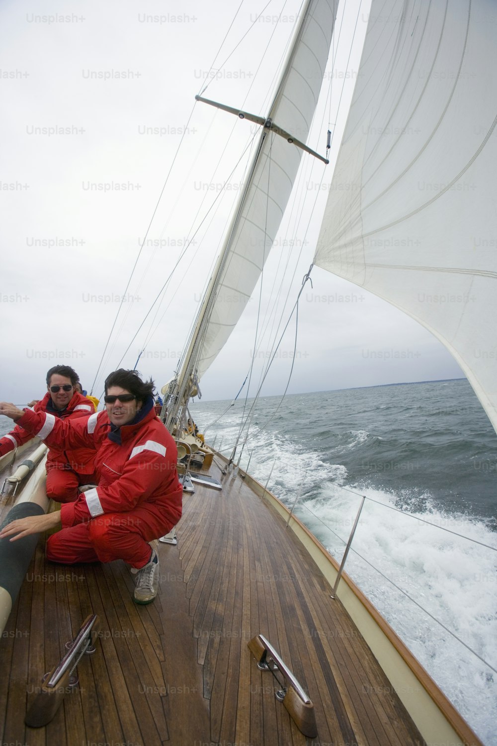 a couple of men sitting on top of a boat