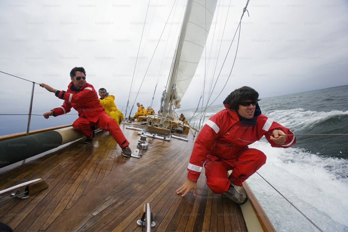 Fleet of racing sailboats under full sail on the open ocean
