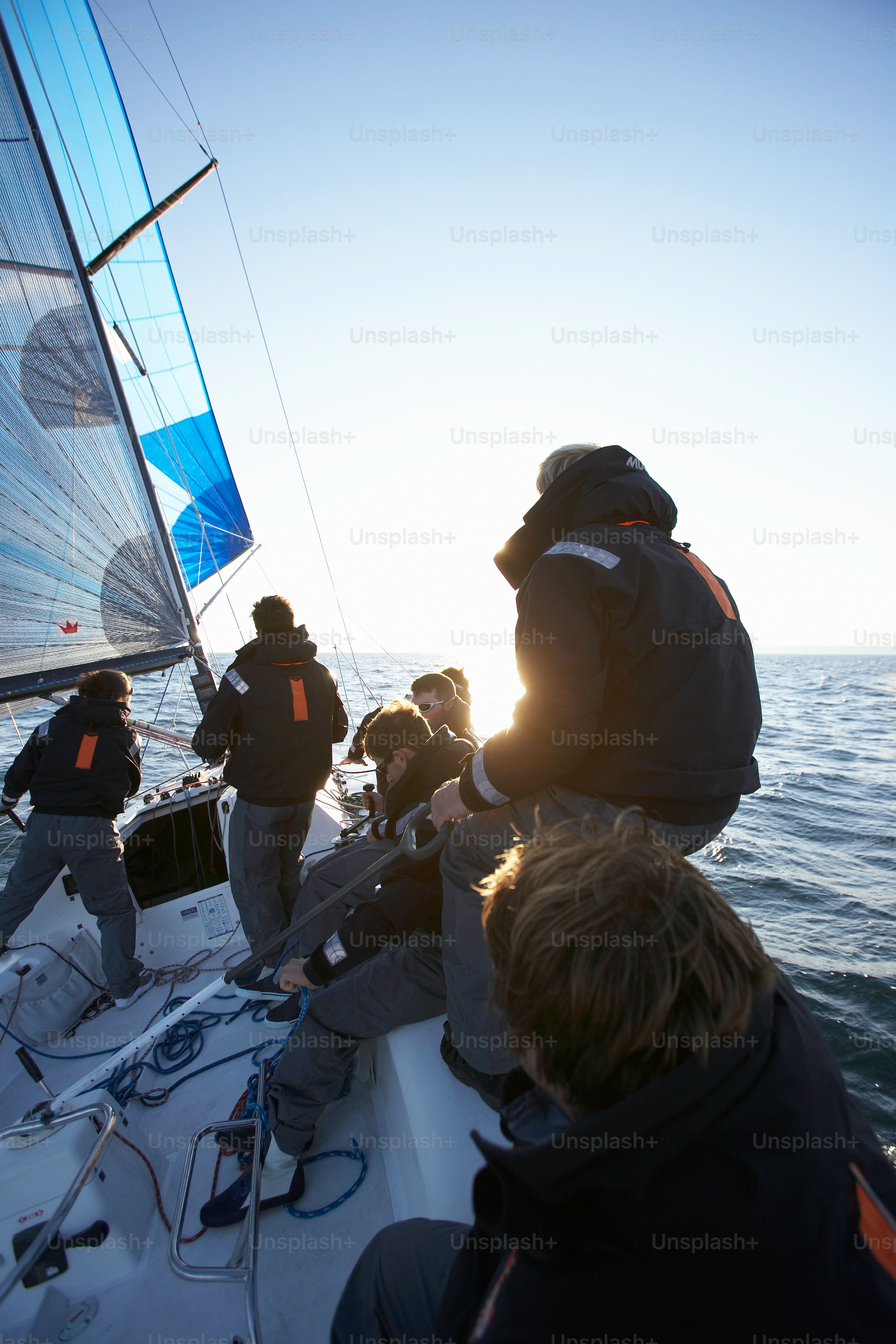 A group of people riding on the back of a sailboat photo – Sea Image on ...