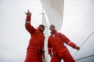 a couple of men standing on top of a boat