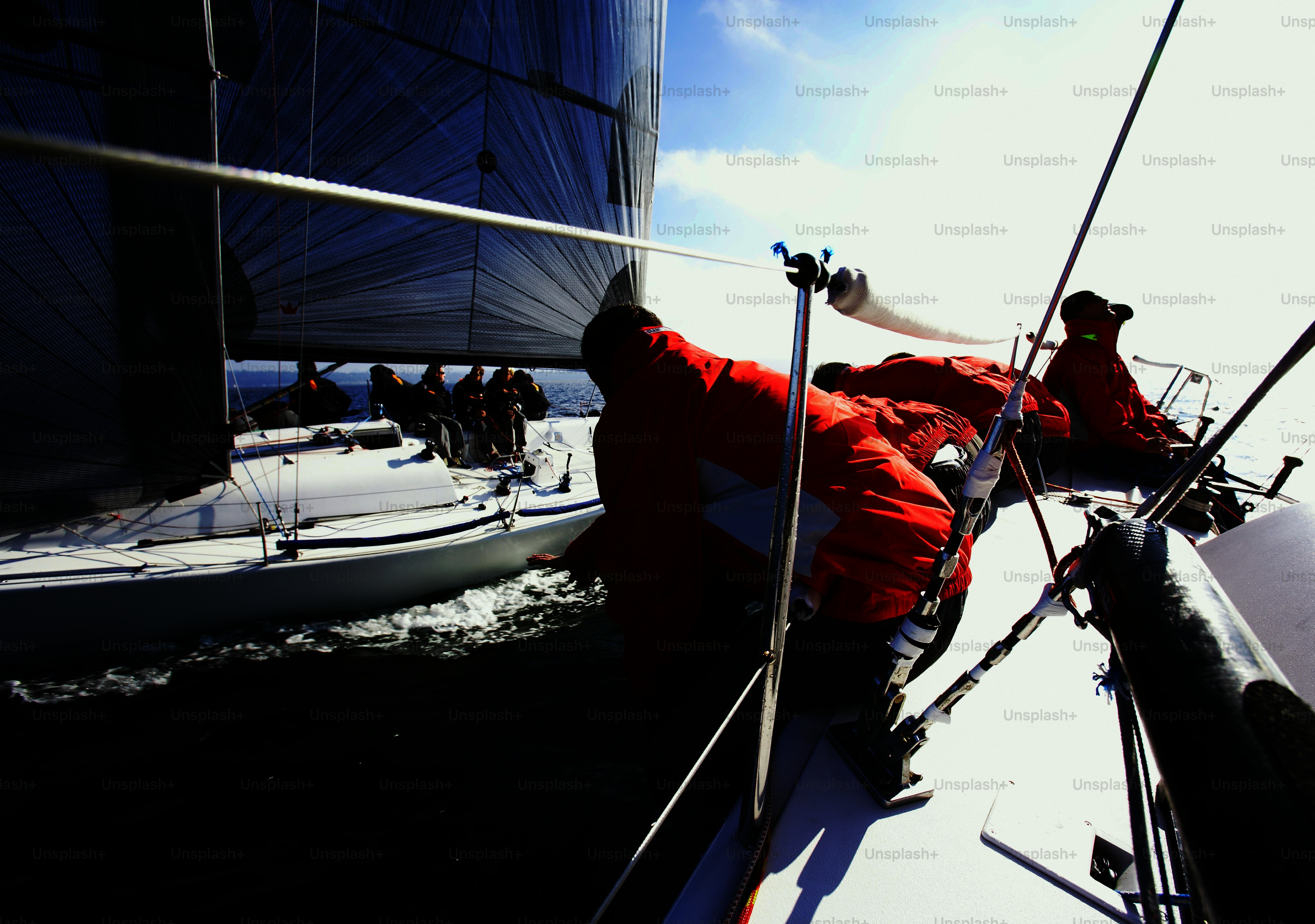 a group of people on a sailboat in the water
